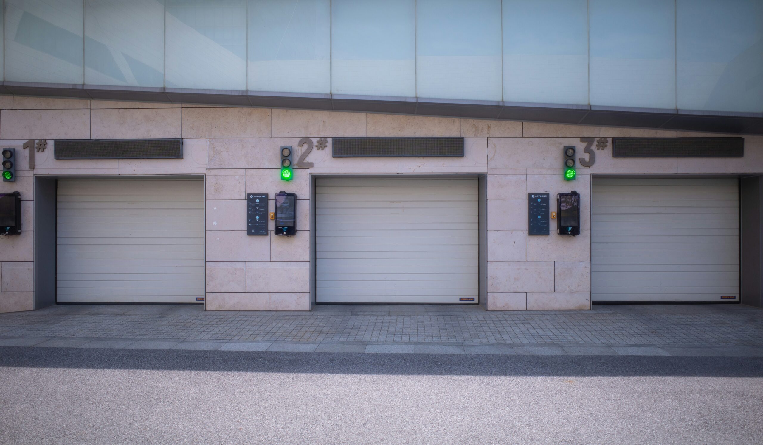 A row of three garage doors sitting next to each other