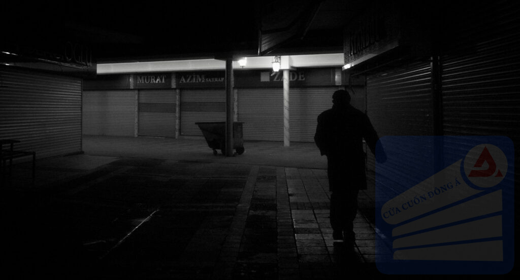 Silhouette walking in a dark, closed marketplace. Night, eerie atmosphere.