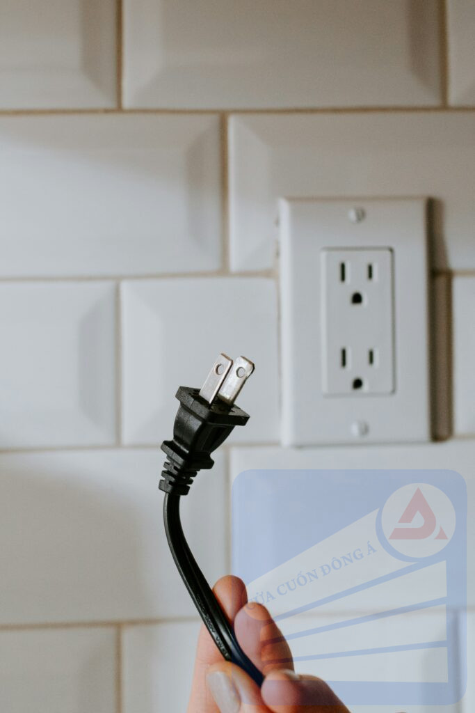black usb cable plugged in white electric socket