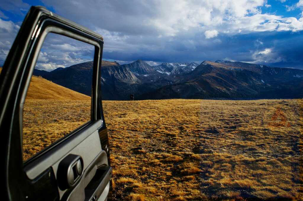 opened vehicle door with mountain alps view