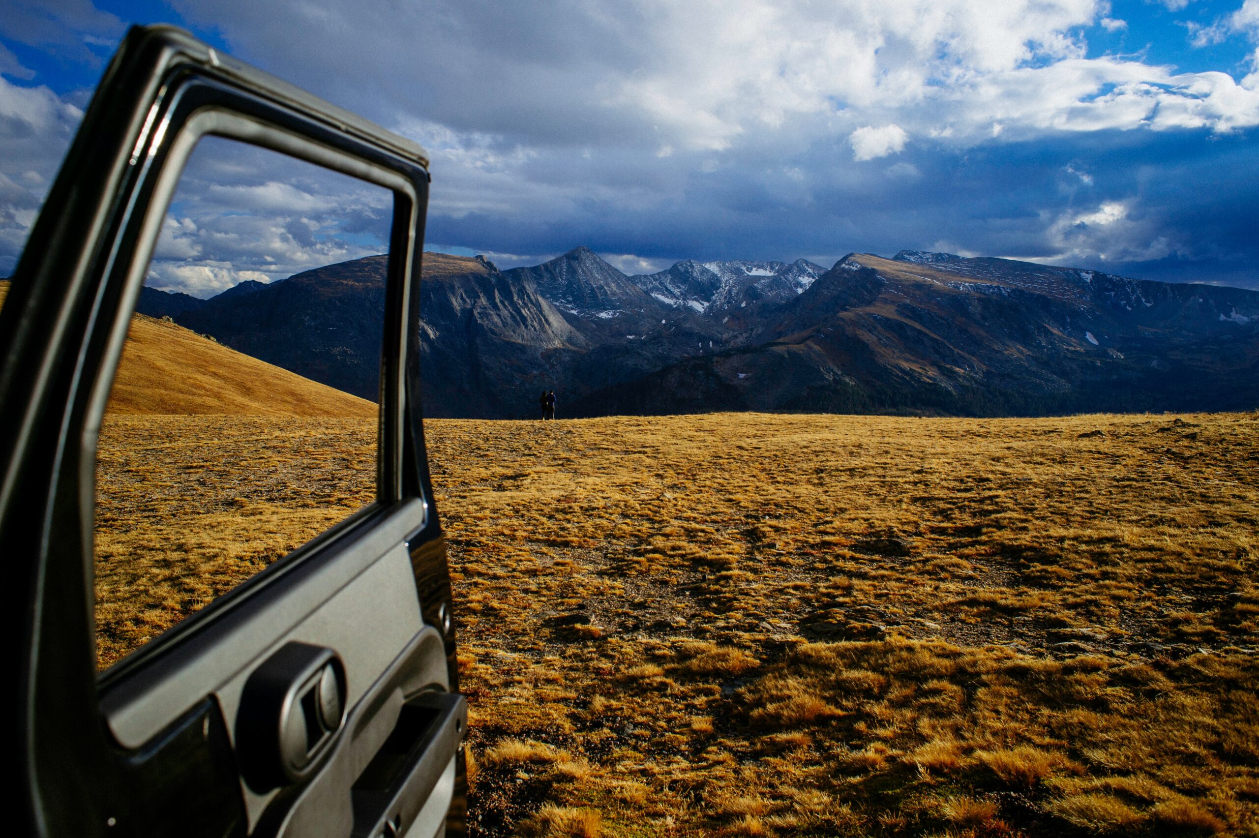 opened vehicle door with mountain alps view